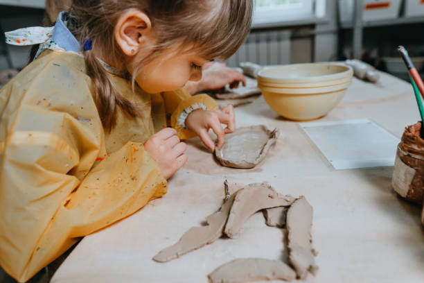 Little girl working with clay