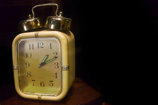 Old-fashioned alarm clock . Time. Antiquities. Copy space available on the right.