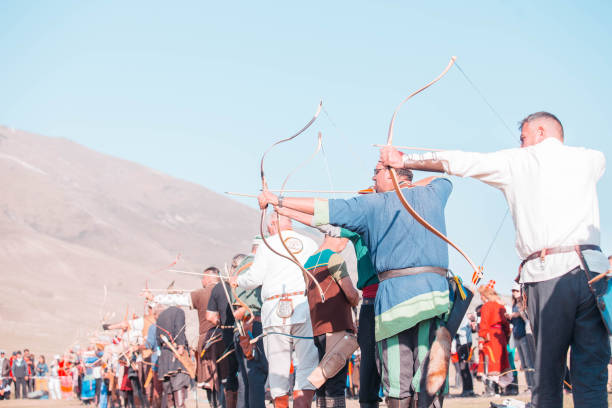 Klaten, Indonesia, august 15, 2023. male and female participants, dressed in Javanese custom pulled his bow by squinting to achieve concentration of target accuracy in traditional Javanese arrow trad