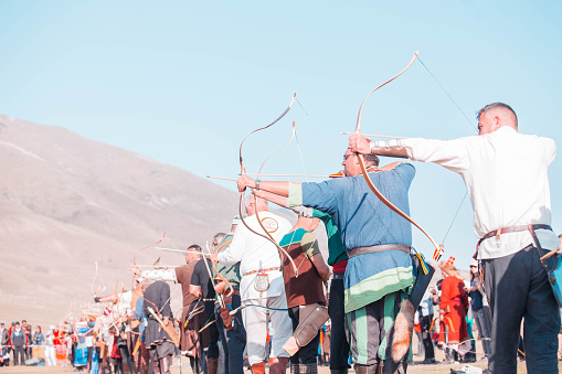 Isyk-Kul, Kyrgyzstan - September ‎29, ‎2018: Men with arrows in bows focused on hitting a target