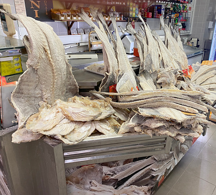 Traditional Portuguese dried cod on fishmonger stall