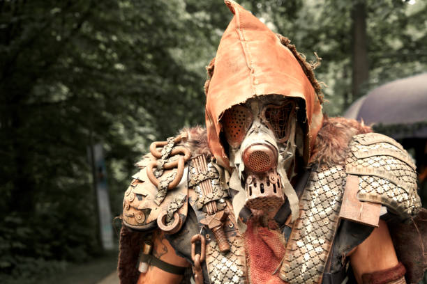 fully covered human with rusty gas mask, tattered hood and leather armor in depressed disguise at a fantasy festival in germany - rust imagens e fotografias de stock