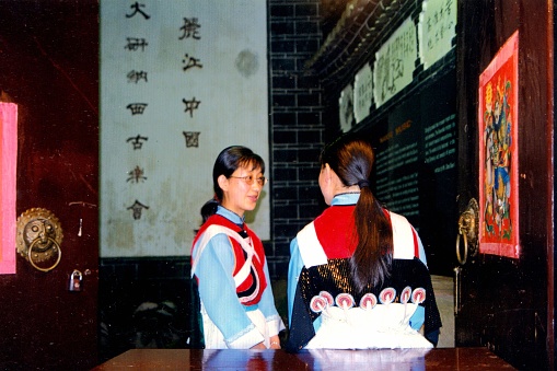 The Chinese characters on the front are:Dayan Naxi Ancient Music Association.Greeting girls before the evening performance.Film photo in July 1998,Lijiang,Yunnan