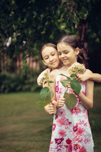 istock Children walk in the summer garden. 1402425595