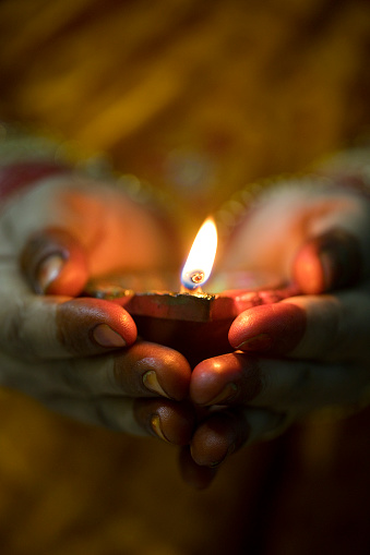 Indian woman holding Diwali oil lamp