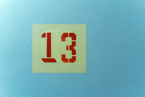 istock The number 13 red in a yellow square on a blue background 1402427518