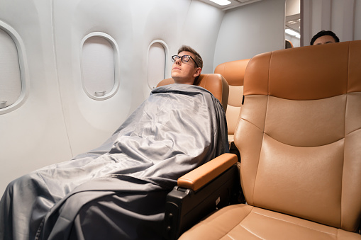 Businessman sleeping in the plane