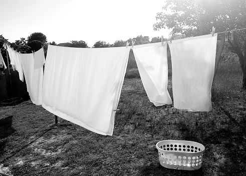 White bed  sheets drying in the sun