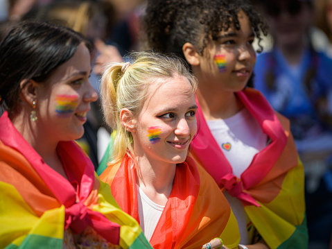 Vienna, Austria - June 11, 2022: People at Vienna Pride on Wiener Ringstrasse, girl with flag