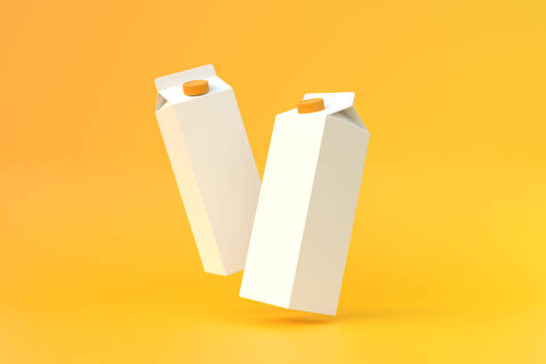 istock Falling milk carton packs on a yellow background 1402432589
