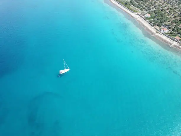 Droneshot from a Sailingvessel on the blue Sea