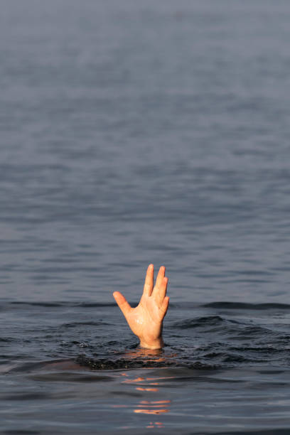 istock Male hand above the water surface. 1402434674
