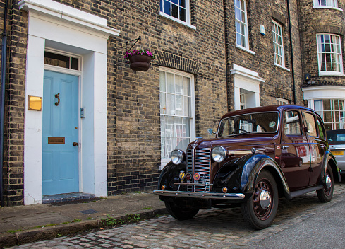 Hadleigh, Suffolk, UK - June 2022: A classic Austin 16 4-door saloon car outside a townhouse in Suffolk, UK