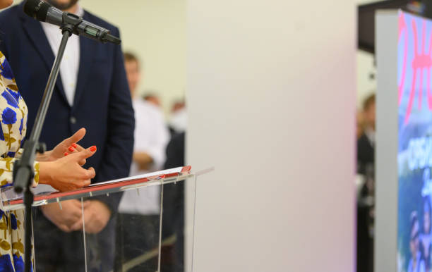istock Female public speaker delivering speech 1402439842