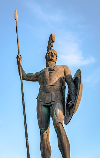 The statue of Achilles in full hoplite uniform, sanding as guardian of the palace in the gardens of Achilleion, in Gastouri, Corfu Island, Greece.
