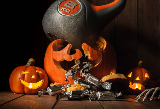 Heavy kettlebell crushing carved Halloween pumpkin.