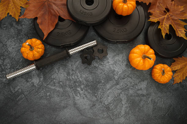 istock Autumn gym composition with dumbbells and pumpkins. 1402445565
