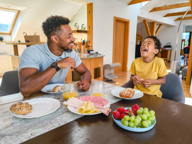 istock Father Eating Breakfast With His Young Son 1402447703