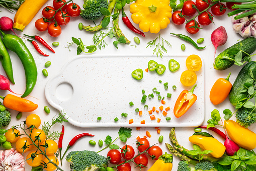 Fresh assorted vegetables and herbs on white background. Healthy clean eating, vegetarian or diet food concept.Food frame. Top view, copy space.