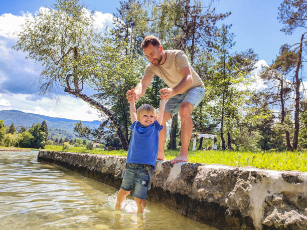 istock Caucasian Father And Son Playing Near The River 1402448004