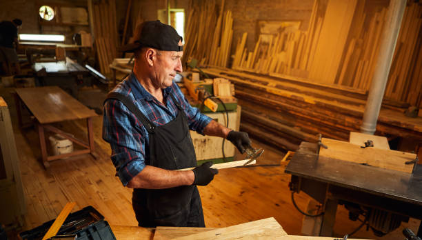 istock Senior professional carpenter working with caliper in the carpentry workshop 1402448863