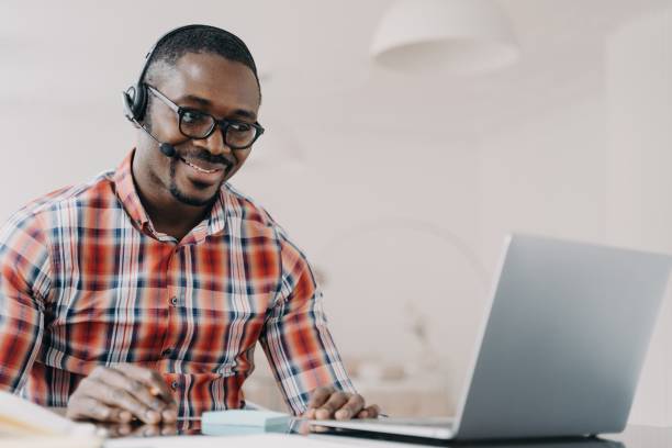 istock African american man support services technician in headset works at laptop communicates with client 1402449210