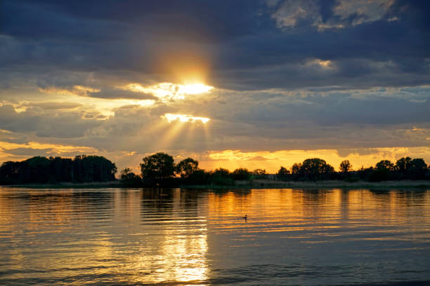 istock Quiet evening over the lake. Bright sunset and ducks on the water surface. Summer. 1402450513
