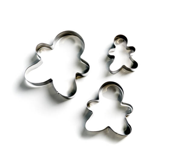 istock Metallic Christmas cookie cutters set on white background. 1402451662