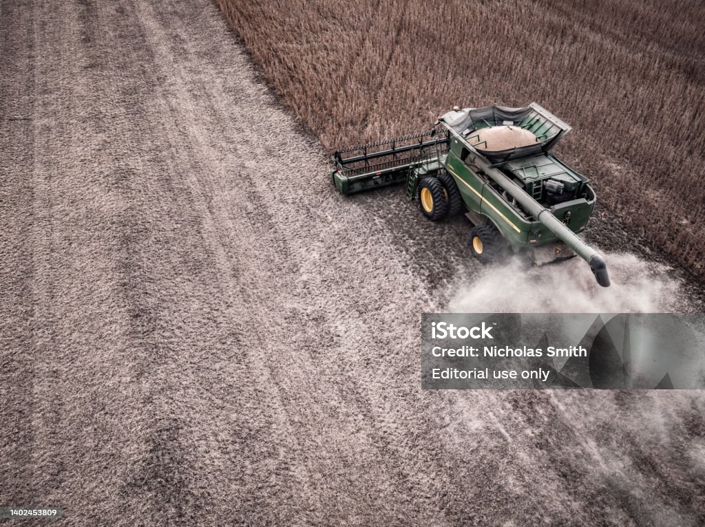 John Deere Combine in Field for Soybean Harvest 2 Henry County, Ohio - October 2, 2021:  A high angle aerial photo via drone looking down on a John Deere S670 combine harvester harvesting the soybeans in a field. John Deere Stock Photo