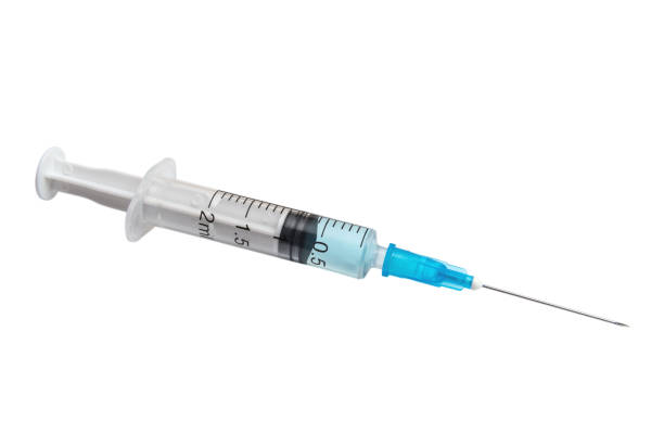 istock Syringe with light blue vaccine isolated on white background 1402454144