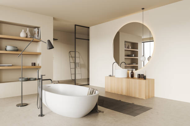 istock Corner view on bright bathroom interior with large round mirror 1402456528