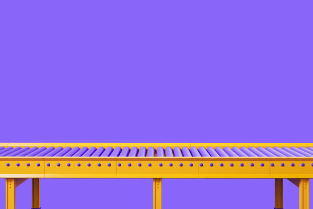 Empty yellow conveyor on violet background, assembly line, copy space stock photo