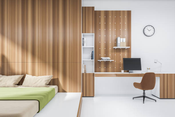 istock Home office interior, bed and table with computer, shelf and books 1402456826