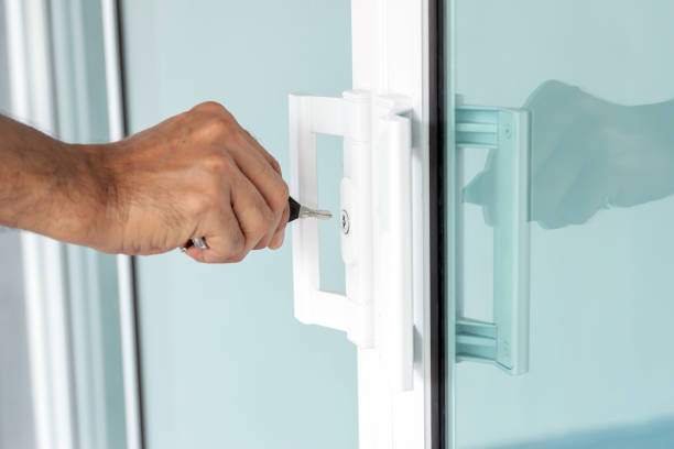 istock Man's hand opening a glass door with a key. 1402458655