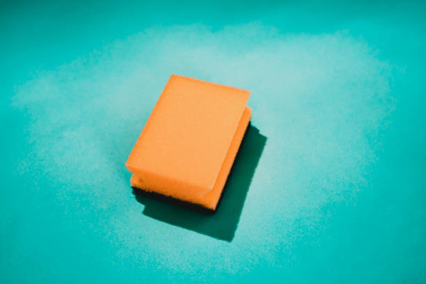 istock Yellow cleaning sponge on a turquoise background 1402459363