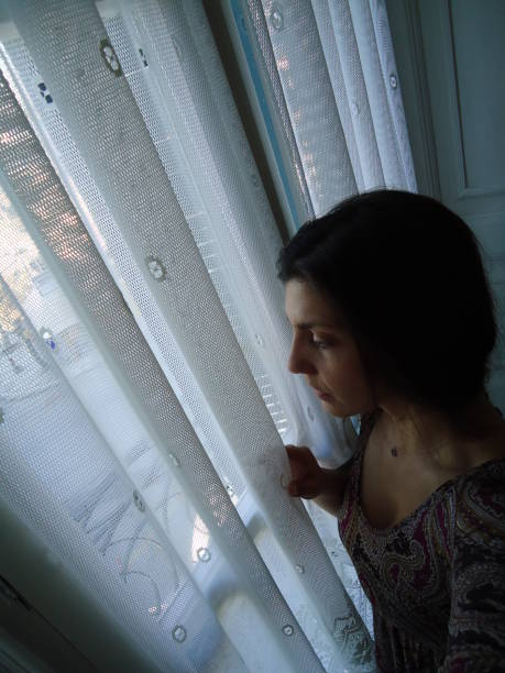 istock Girl looking out of the window 1402459366