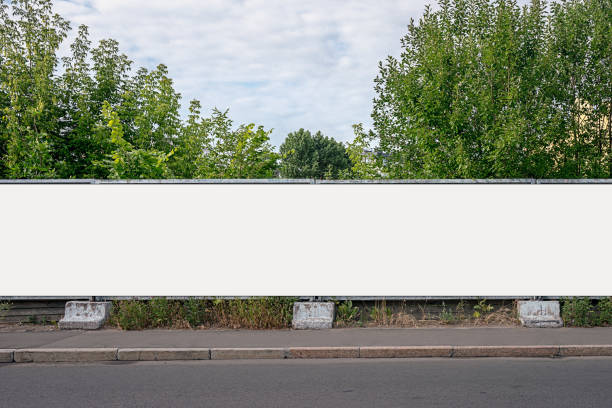 istock Advertisement long empty banner mounted on cement fence outdoor. 1402462168