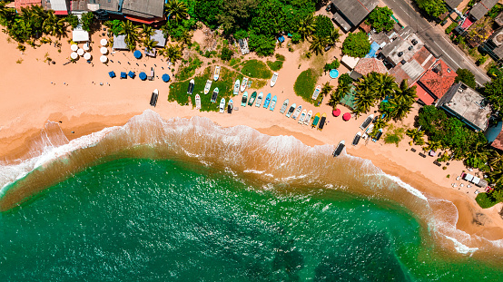 Aerial view of beach waves splashing sandy beach