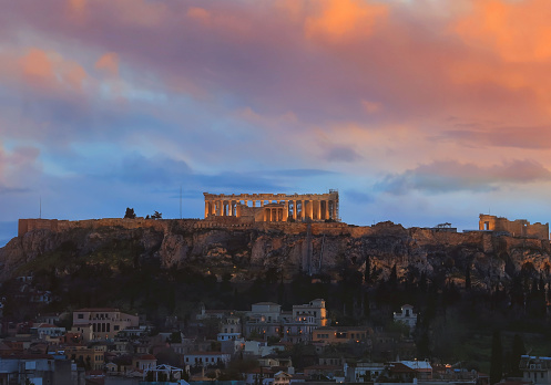 The  Acropolis of Athens, Greece, with the Parthenon Temple on top of the hill during a summer sunset skyline scene background