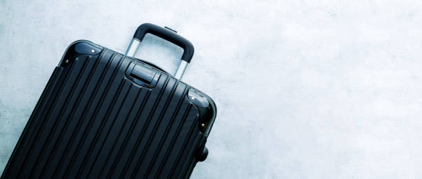 istock Black travel bag,Black luggage set on dark background, top view image, flat lay composition. Travel minimalist concept, black and dark classic baggage mockup, small and big. Suitcase accessory set, journey concept. 1402473895