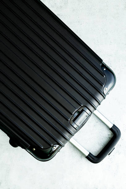 istock Black travel bag,Black luggage set on dark background, top view image, flat lay composition. Travel minimalist concept, black and dark classic baggage mockup, small and big. Suitcase accessory set, journey concept. 1402473913