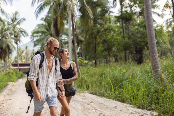 istock Woman admiring the nature, while exploring rainforest with her boyfriend 1402475763