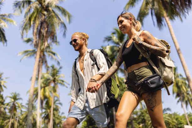 istock Low angle view of couple holding hands while exploring the rainforest 1402475805
