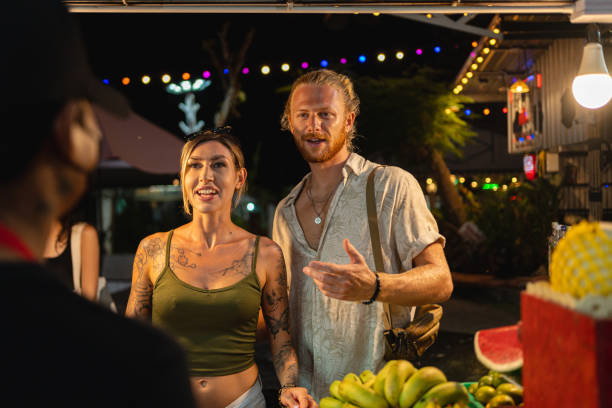 istock Caucasian couple ordering at the night market 1402476614