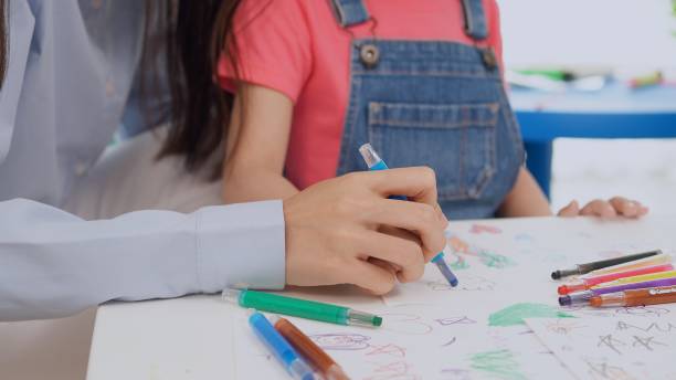 istock Preschool teacher with children study in classroom. Kindergarten back to school 1402476676