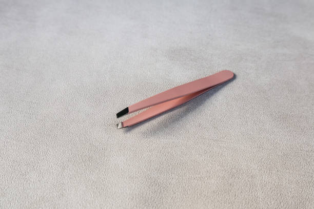 istock tweezers on the table in gray with a slightly rough texture 1402479192