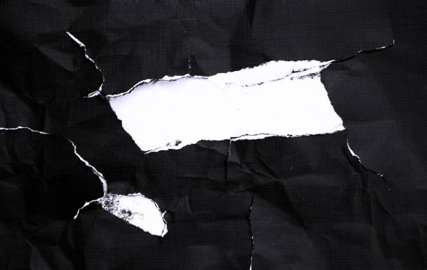 istock Black paper with white tears for the background 1402479468