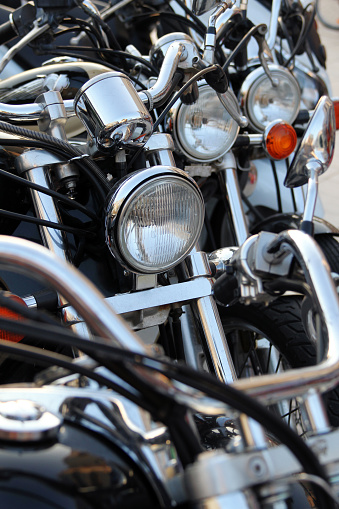 Close-up of a lot of motorcycles in a row.