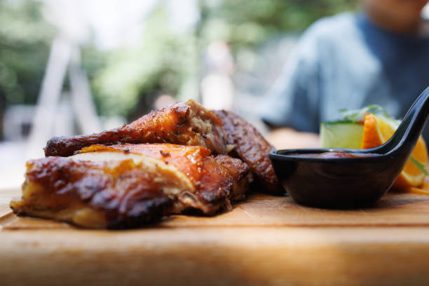 Barbecue chicken is being grilled over charcoal