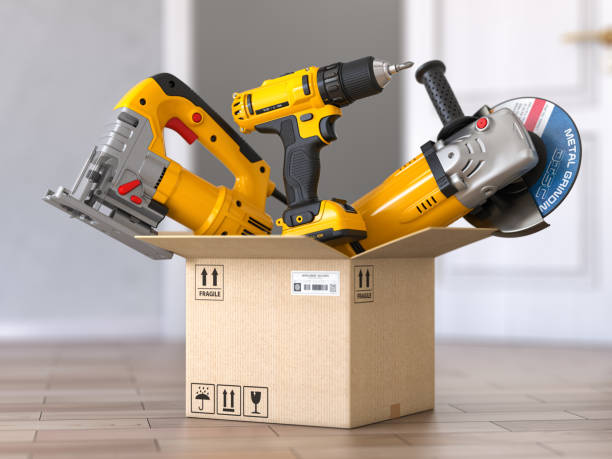 istock Cardboard box with elecric tools and construction equipment angle grinder, electric drill and jigsaw.  Buying online and fast delivery concept. 1402483239